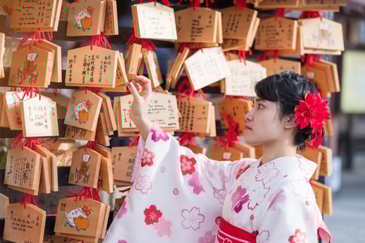 young woman tourist wearing kimono in Kiyomizu dera temple, Kyoto, Japan. Asian girl with hair style in traditional Japanese clothes in Autumn foliage season photo
