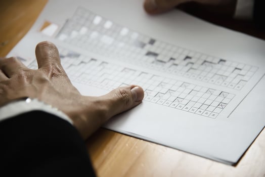 Instructor checking multiple choices answer sheet exam - education people working with paper test concept photo