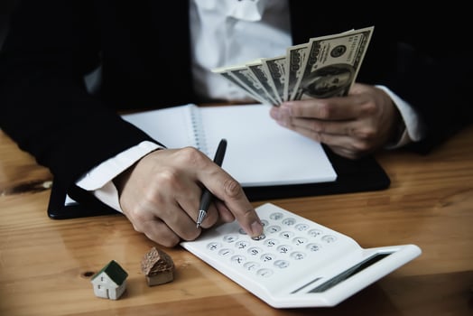 Business man show money bank note make financial plan invite people to sell or buy house and car - monetary properties loan credit insurance concept photo