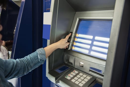 People waiting to get money from automated teller machine - people withdrawn money from ATM concept photo
