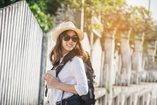 Young woman backpack traveler in small city - outdoor asian traveler activity concept photo