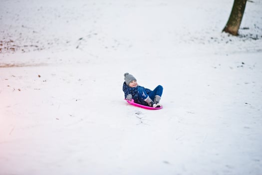 Cute little girl with saucer sleds outdoors on winter day. photo