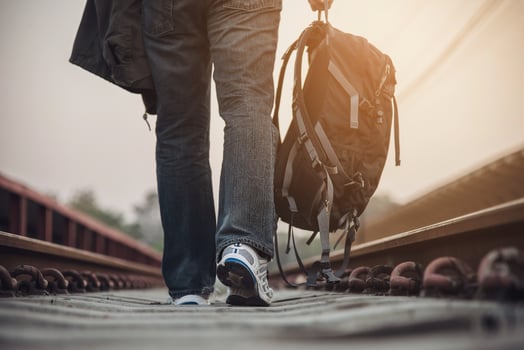 Travel man wait train at platform - people vacation lifestyle activities at train station transportation concept photo