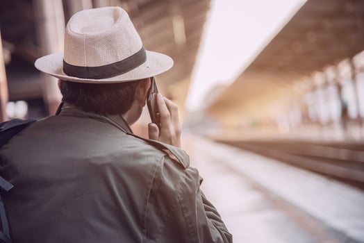 Travel man wait train at platform - people vacation lifestyle activities at train station transportation concept photo