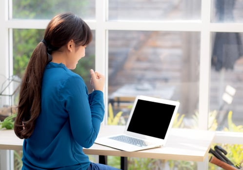 Beautiful portrait asian young freelance woman working online laptop with smile and happy at cafe shop, girl using notebook computer with excited and glad, business and success concept. photo