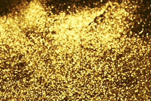 Golden glitter bokeh lighting texture Blurred abstract background for birthday, anniversary, wedding, new year eve or Christmas photo