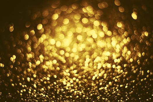 Golden glitter bokeh lighting texture Blurred abstract background for birthday, anniversary, wedding, new year eve or Christmas photo