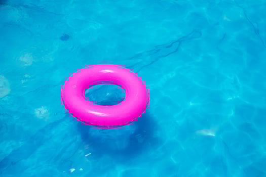 toy swim float in bright blue pool water photo