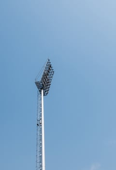Modern spotlight pole under the clear blue sky. photo