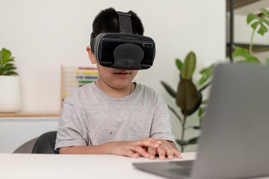 Asian Little boy with VR glasses studying sciences at home,curious student wears a virtual reality headset to study science home online study futuristic lifestyle learning photo