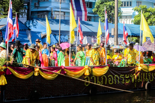 SAMUTSAKORN, THAILAND - JULY Big Boat and People in Parade candle to temple at Katumban in Samutsakorn, Thailand on July 16, 2019 photo