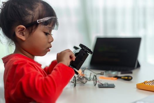 Asia students learn at home in coding robot cars and electronic board cables in STEM, STEAM, mathematics engineering science technology computer code in robotics for kids concept. photo