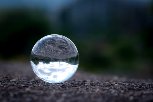 A lens ball with inverted landscape view. Close up image of a glass ball. photo