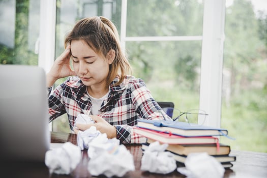 woman sitting down, his face unsettled photo