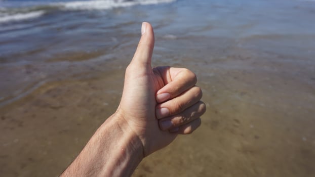 Thumbs up on the beach photo