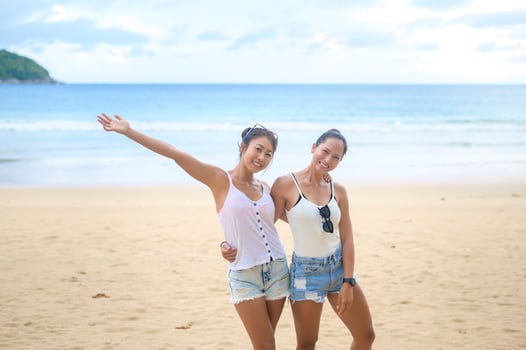 Two women enjoying and relaxing on the beach,  Summer, vacation, holidays. photo