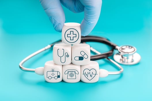 Health insurance concept. Medical symbols on cube shape blocks and Hand holding a block with healthcare medical icon photo