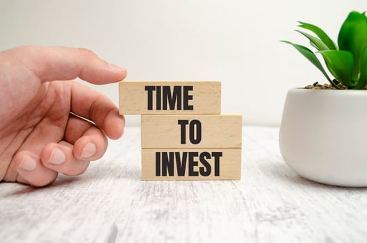 three wooden blocks with the words TIME TO INVEST photo