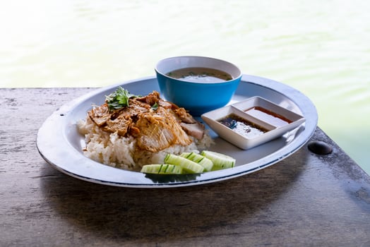 roasted pork with rice at river side photo