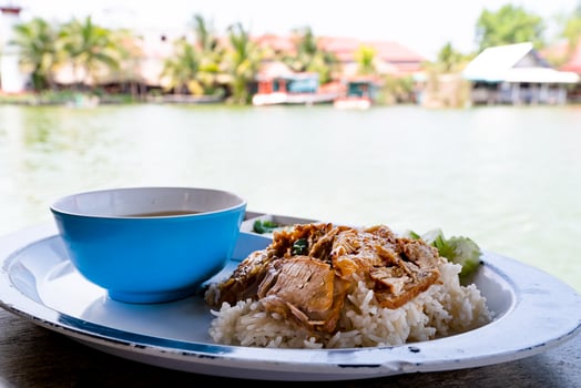 roasted pork with rice at river side photo
