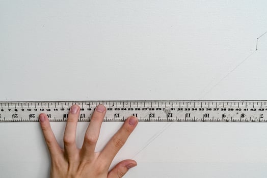 hand holding ruler with canvas background photo