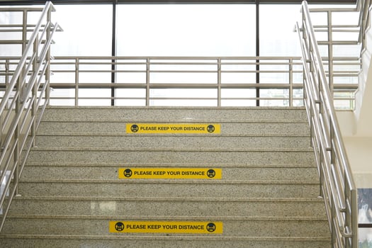 Please keep your distance label on the university stairs or building. real distance label.rectangle yellow labels. photo