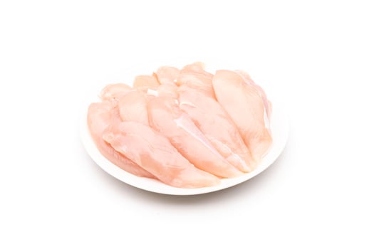 Raw chicken breast in white dish isolated on white photo