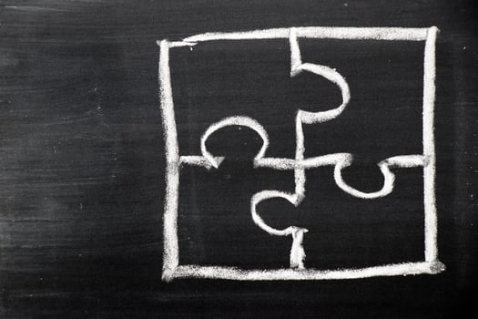 Chalk hand drawing as puzzle shape on black board background photo