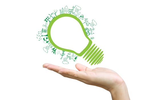 Hands holding green ecology light bulb photo