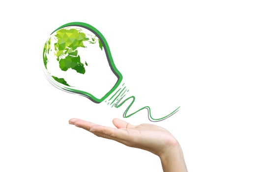 Hands holding green ecology light bulb photo