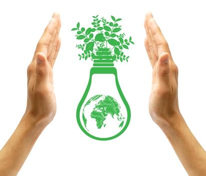 Hands holding green ecology light bulb photo
