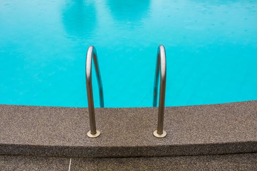 Swimming pool with stair at hotel close up photo