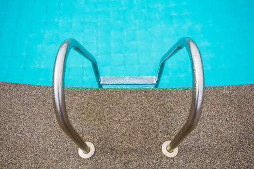 Swimming pool with stair at hotel close up photo