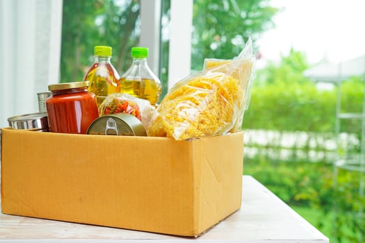 Foodstuffs in donation box for volunteer. photo
