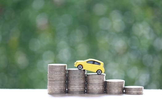 Miniature car model on growing stack of coins money on nature green background, Saving money for car, Finance and car loan, Investment and business concept photo