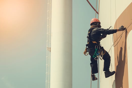 Male worker rope access height safety inspection of thickness storage oil and gas tank photo