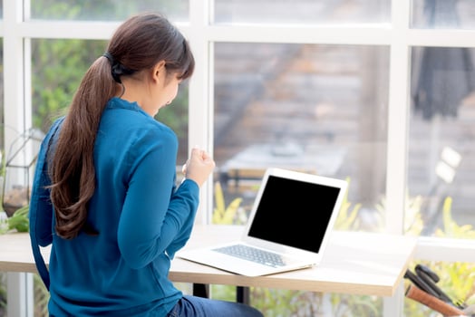 Beautiful portrait asian young freelance woman working online laptop with smile and happy at cafe shop, girl using notebook computer with excited and glad, business and success concept. photo
