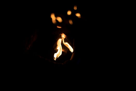 Flames in dark. Details of fire. Fire on black background. photo