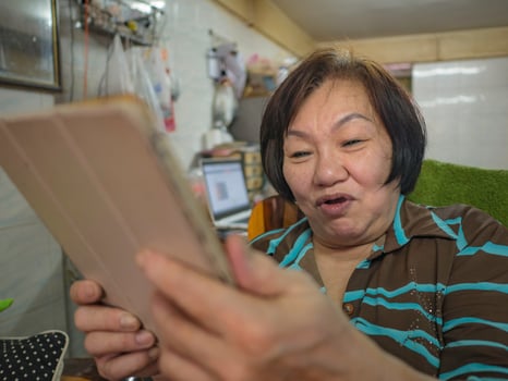 Grandmother use her tablet video conference to talk with her Grandchild photo
