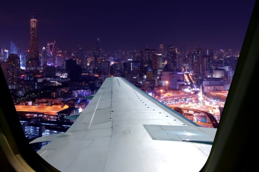 Evening flight on twilight sky, amazing view from the window plane. Window seat on airplane overlooking  city at night view . photo