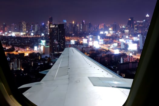 Evening flight on twilight sky, amazing view from the window plane. Window seat on airplane overlooking  city at night view . photo