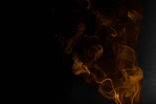 orange smoke on a black background photo