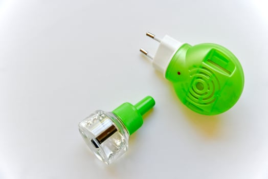 Electric mosquito Repellent fumigator on a white background with liquid photo