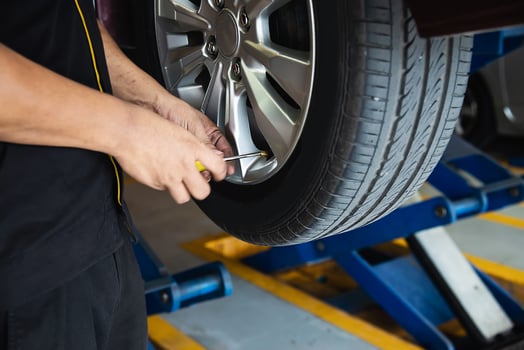 Technician is inflate car tire - car maintenance service transportation safety concept photo