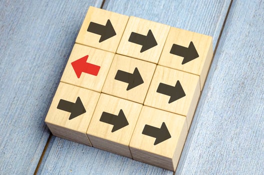 Wooden Block With Red Arrow Facing The Opposite Direction Black Arrow photo