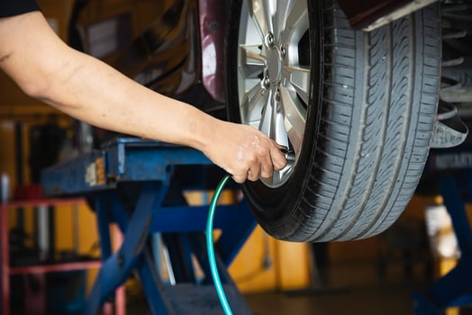 Technician is inflate car tire - car maintenance service transportation safety concept photo