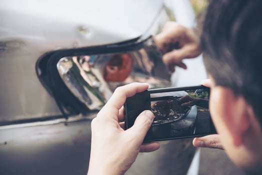 Insurance agent working during on site car accident claim process - people and car insurance claim concept photo