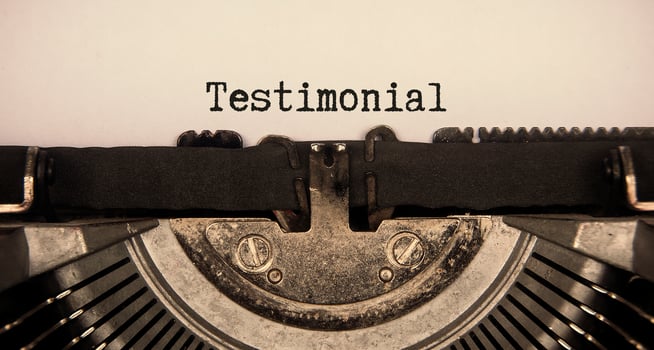 Testimonial text typed on an old vintage typewriter. Conceptual photo