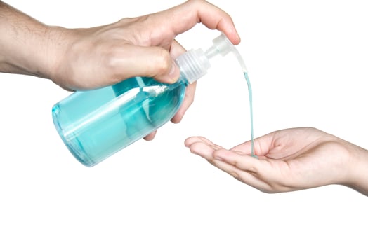 Closeup of father hand pushing alcohol sanitizer gel pump dispenser to son hand isolated over white background - people with alcohol sanitizer prevent bacteria and COVID-19 virus protection concept. photo