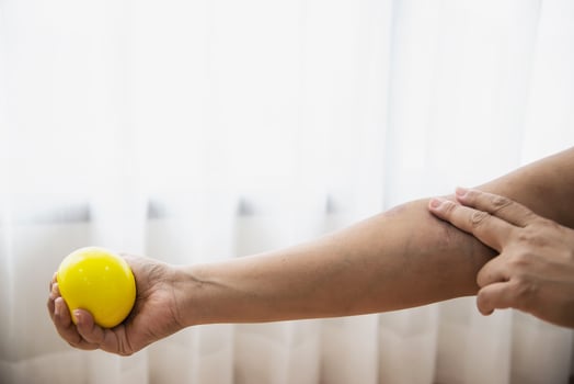 Soft finger and hand exercise ball in patient hand - healthcare medical concept photo